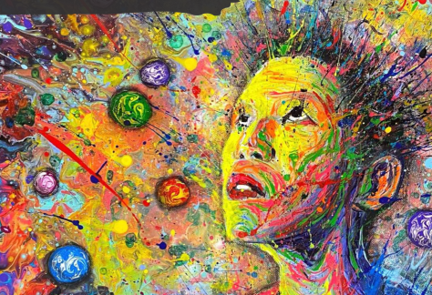 A person looks upwards with an explosion of colours and shapes all around them